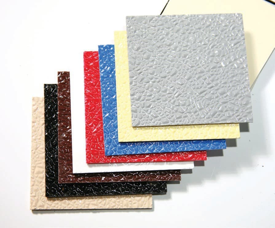 Eight squares of embossed FRP fanned out on a table: beige, black, brown, white, red, blue, yellow and gray.