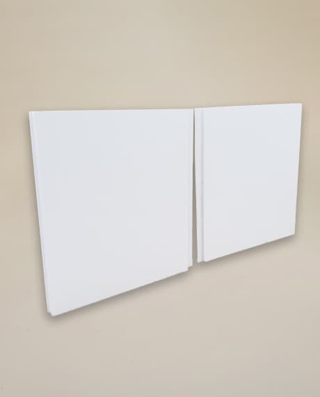 Two smooth white interlocking panels, the tongue-and-groove edge visible where they meet.