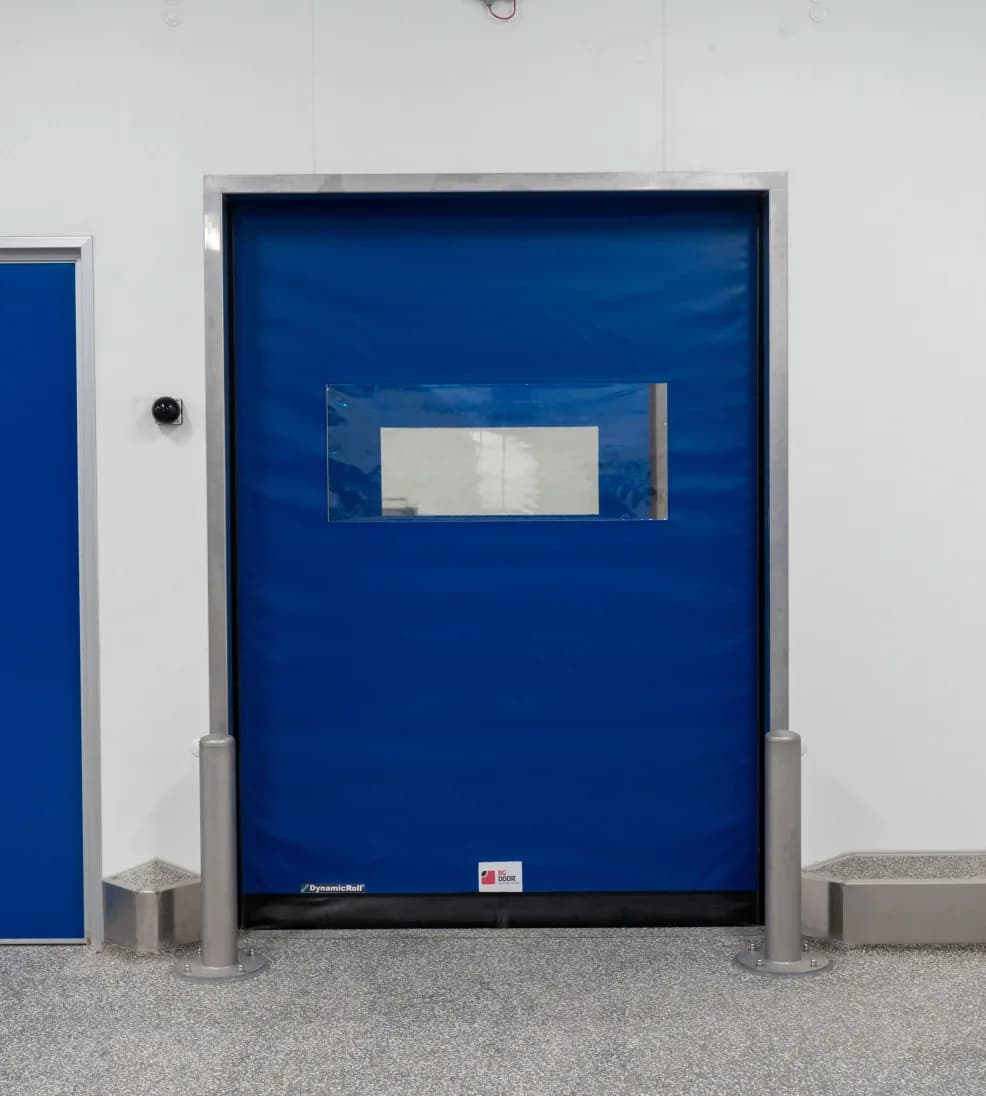 Dynadry rapid door with a blue curtain and vision panel in a stainless frame