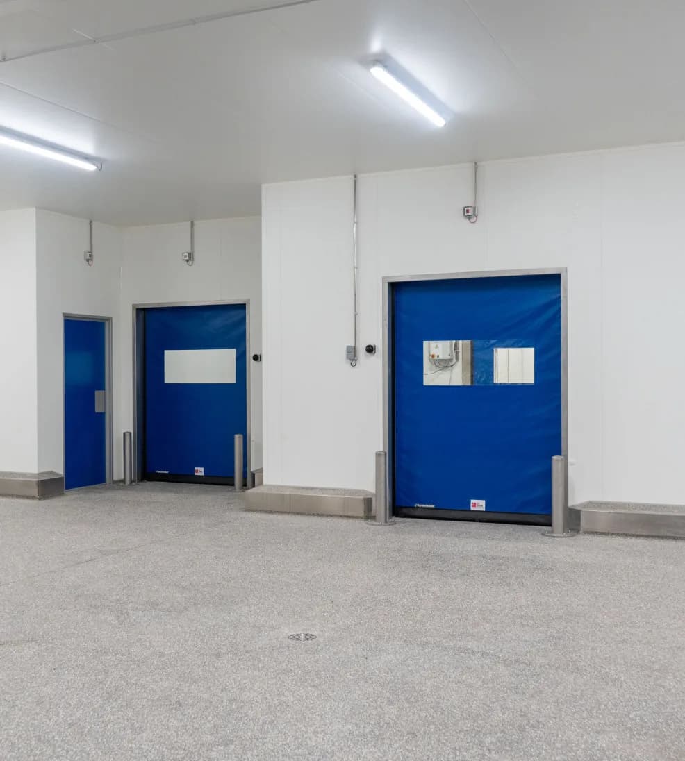 Dynadry rapid doors with blue curtains along a white wet-room wall