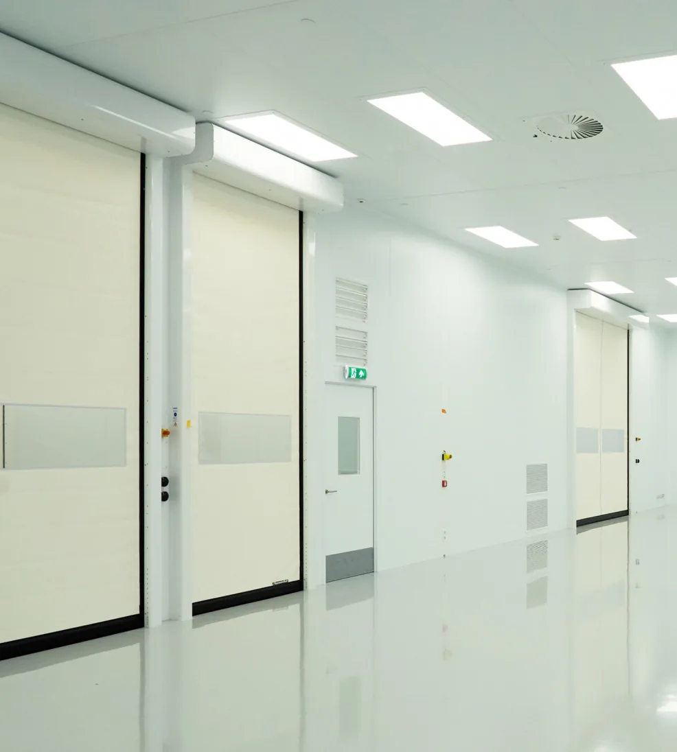 DynamicRoll CB 230 cleanroom high-speed doors along a white pharmaceutical corridor