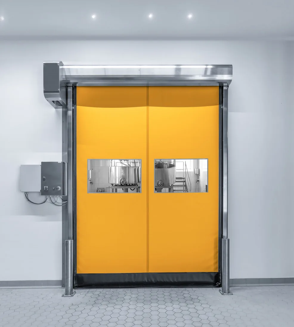 DynamicRoll Stainless high-speed door with an orange curtain and vision panels in a stainless frame