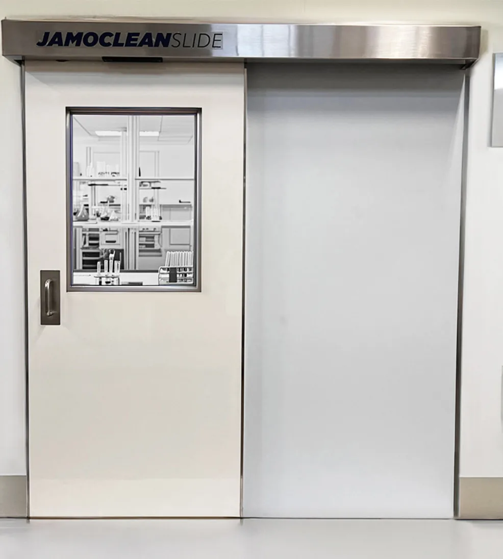 Jamoclean sliding cleanroom door with a vision panel opening onto a laboratory