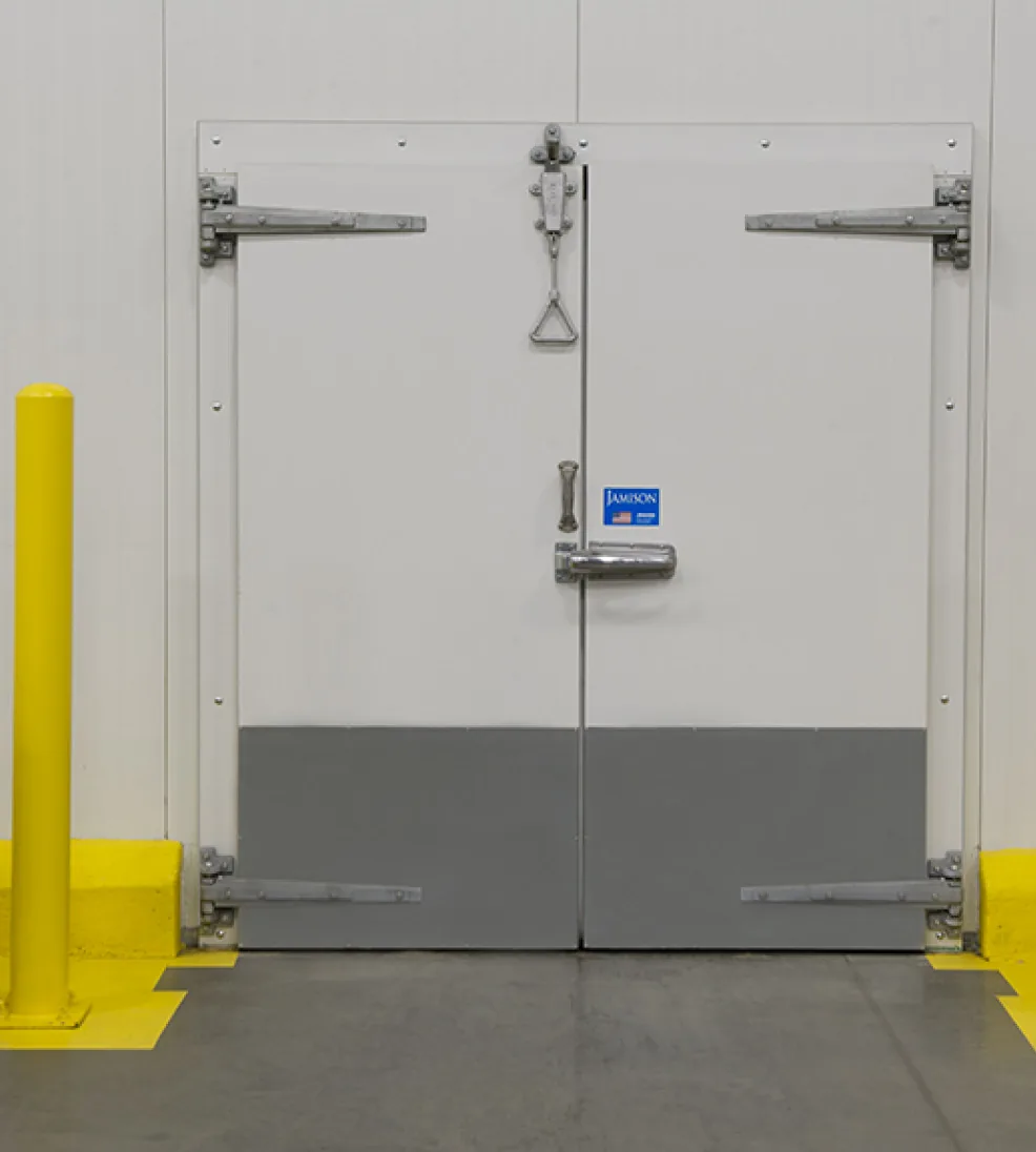 White bi-parting Jamofoam I double swing doors with gray kick plates and heavy strap hinges