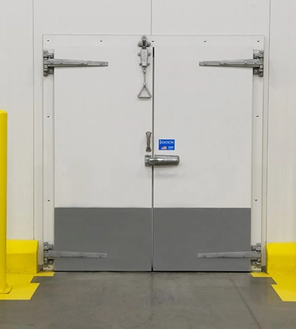 White bi-parting Jamofoam I swing freezer doors with gray kick plates and heavy strap hinges