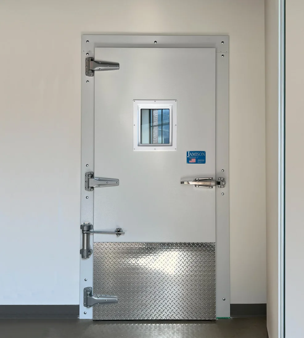 White Jamofoam II swing freezer door with a small vision window and diamond-plate kick plate