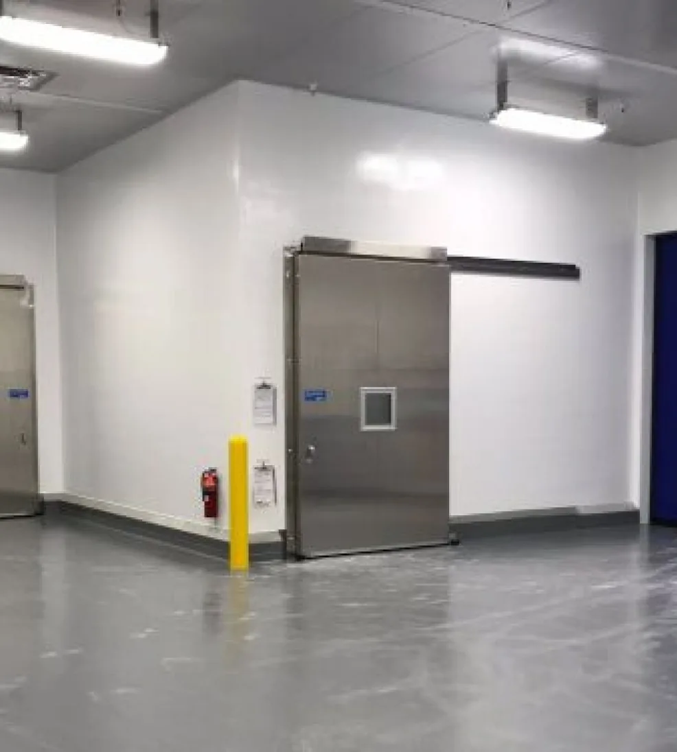 Stainless Jamofood sliding door with a vision window in a white food-plant corridor