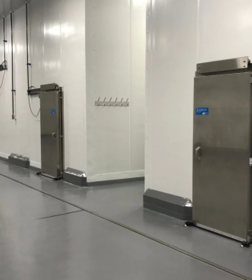 Stainless Jamofood sliding doors along a wash-down corridor with stainless wall guards