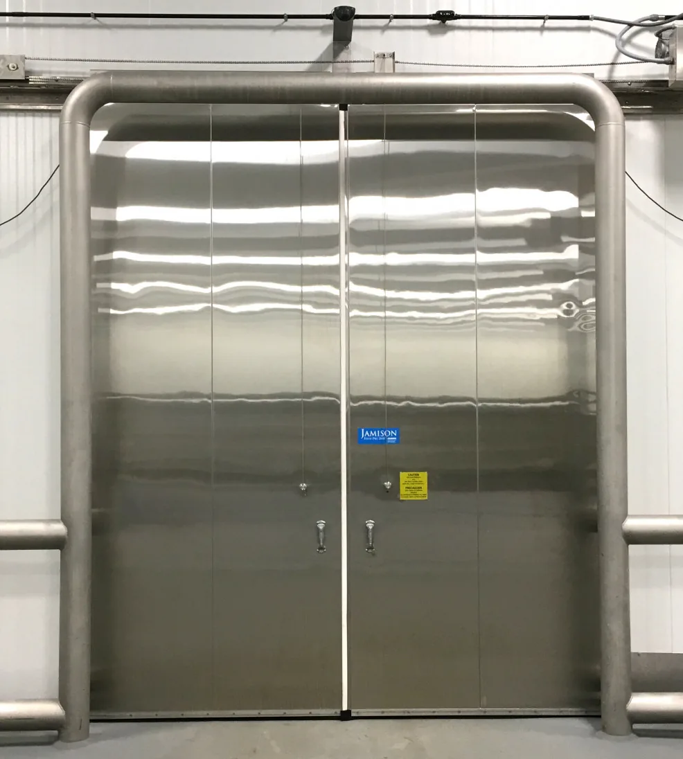 Stainless steel Jamofood bi-parting sliding freezer doors inside a stainless bumper frame