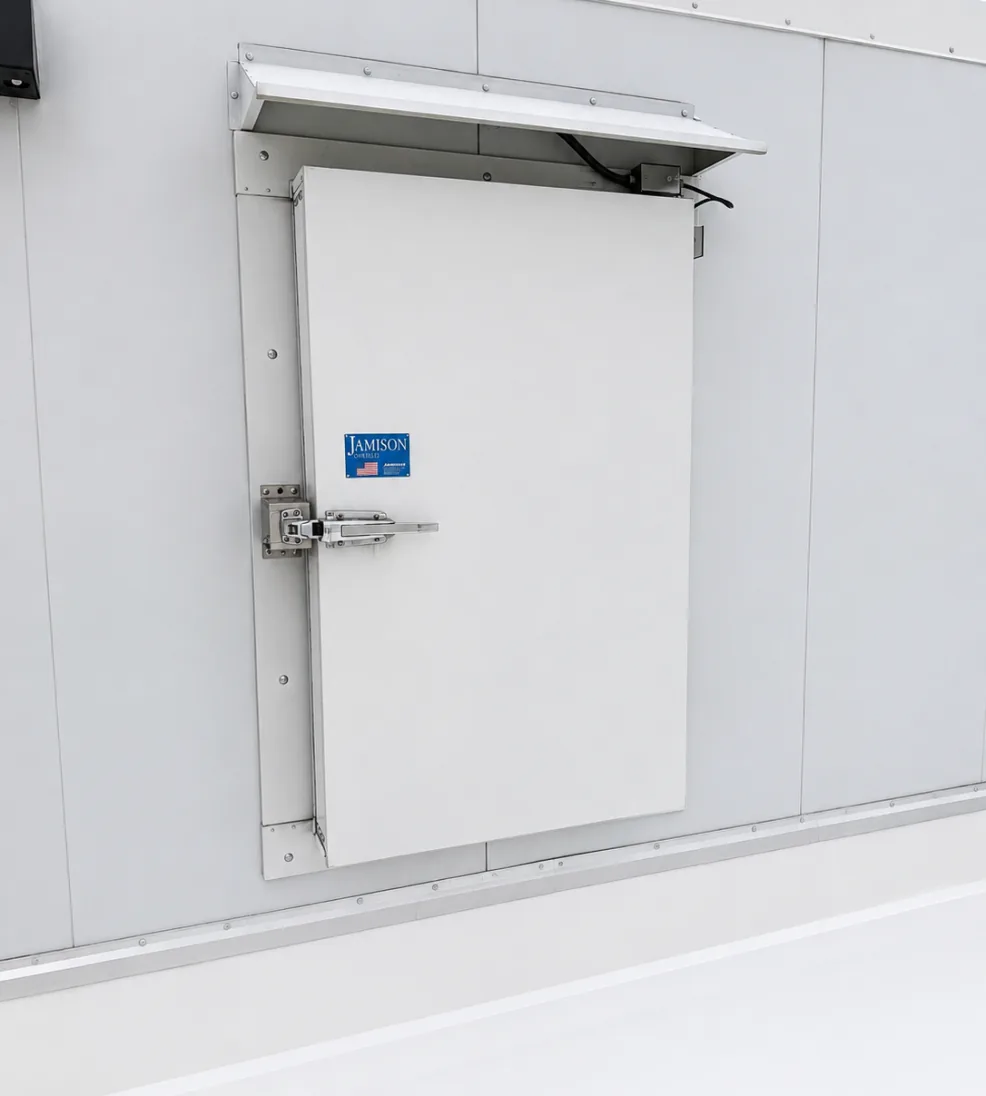 Jamoguard overlap door panel closing against the face of its frame, with a weather hood above