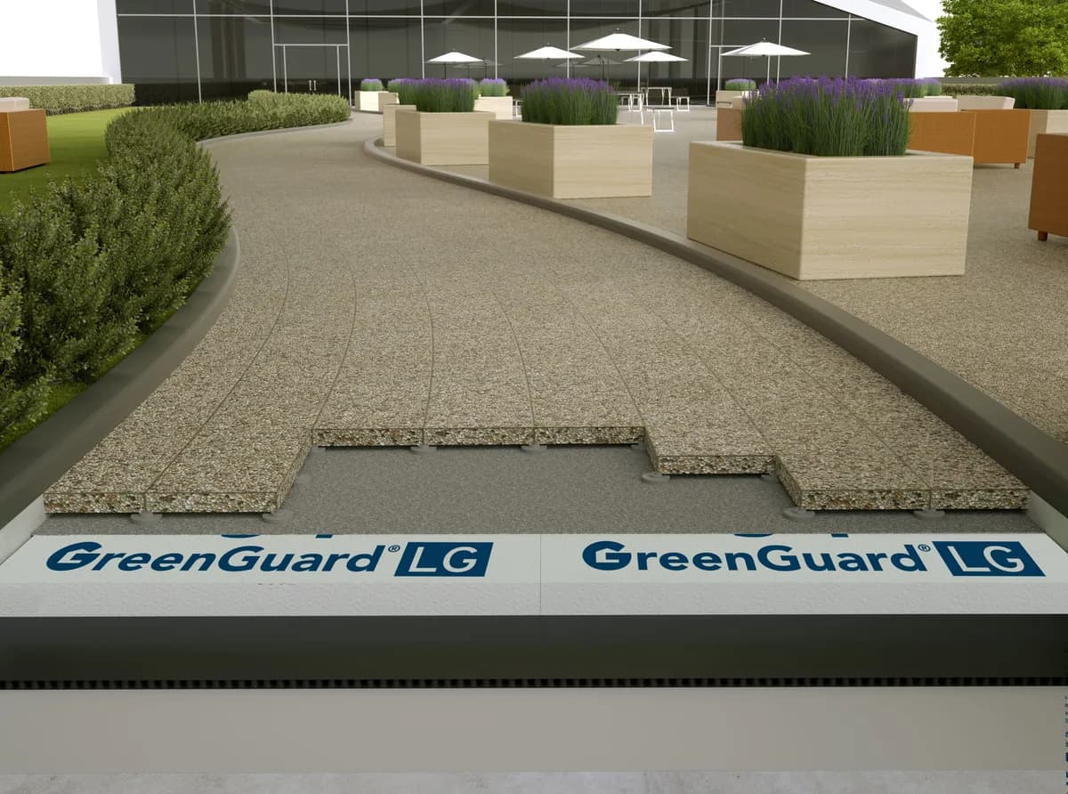 GreenGuard LG XPS boards laid under a paved plaza deck, shown in cutaway beneath the paving