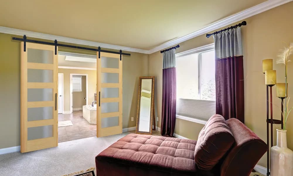 A pair of wood barn doors with tall frosted glass panels on one overhead track
