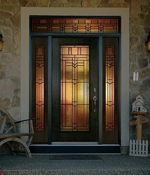A dark entry door with amber art glass in the door, both sidelites and the transom