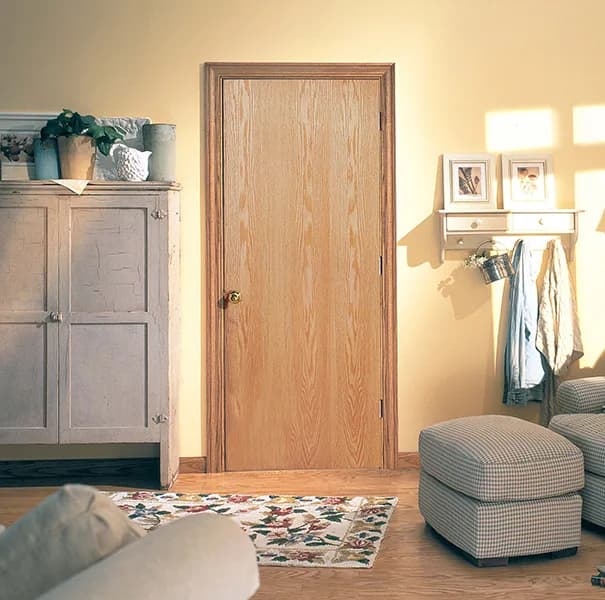 An oak flush interior door in a hallway