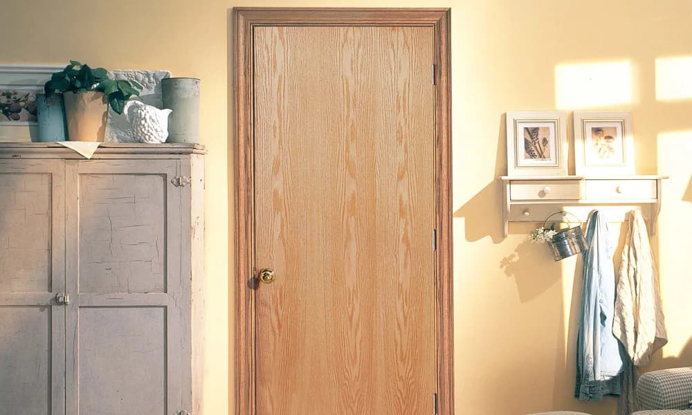 An oak flush interior door in a hallway