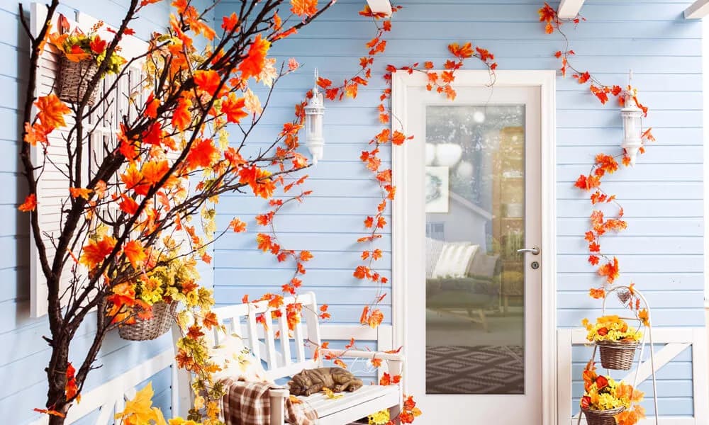 A white flush glazed entry door with one large glass pane on a blue porch