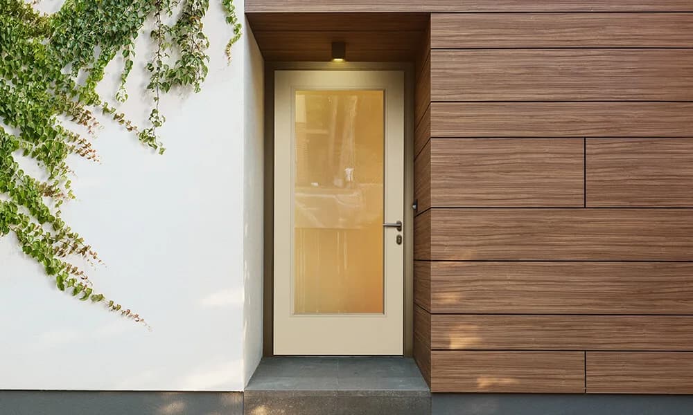 A flush glazed door with a full frosted glass pane in a modern wood-clad entry
