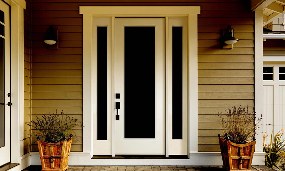 A white flush glazed entry door with dark glass and two sidelites