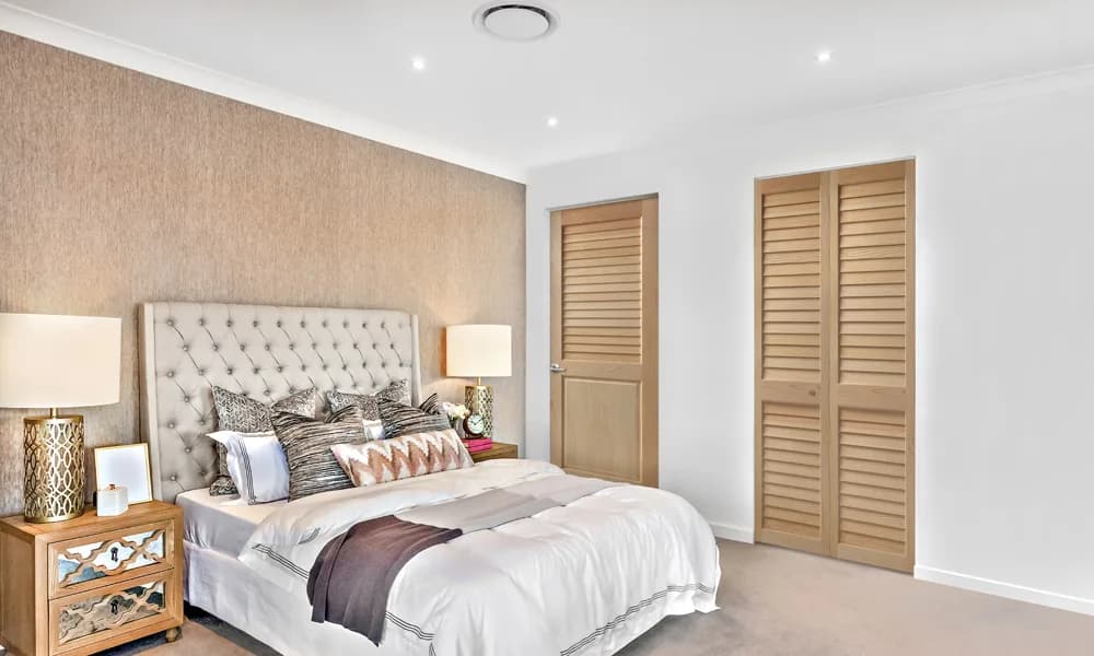 A natural pine louver door and a pair of louver closet doors in a bedroom