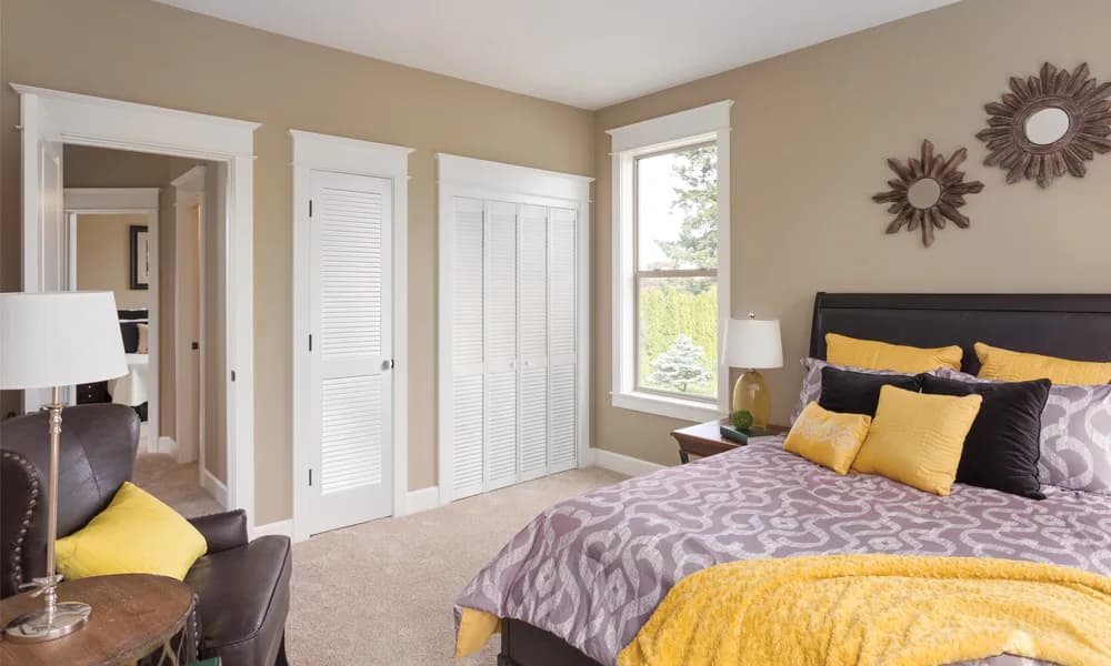 White louver closet doors in a bedroom
