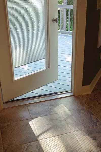 An open door showing the blinds sealed between the glass panes