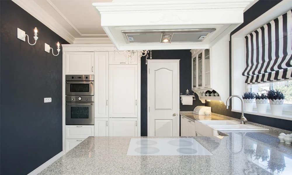 A white molded door at the end of a kitchen