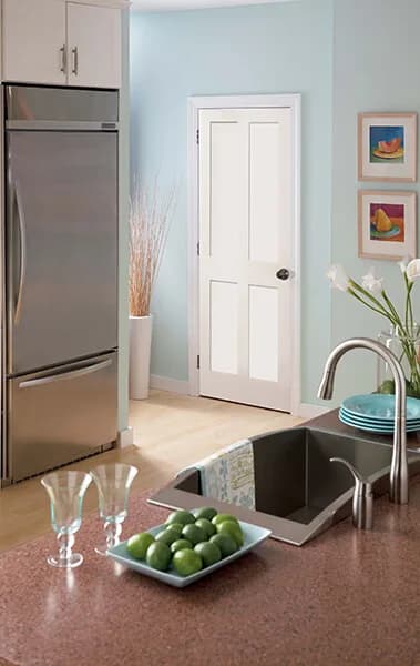 A white two-panel stile and rail door beside a kitchen