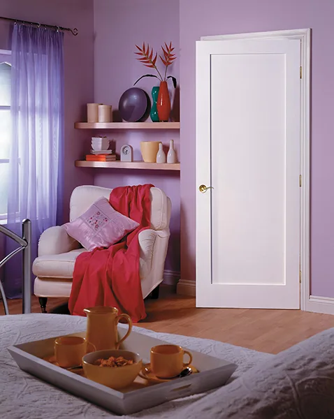 A white one-panel door in a lilac room